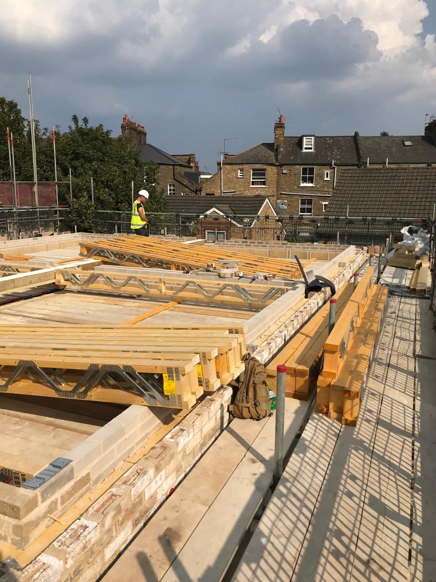 First-fix timber floor joists laid out across a new-build structure