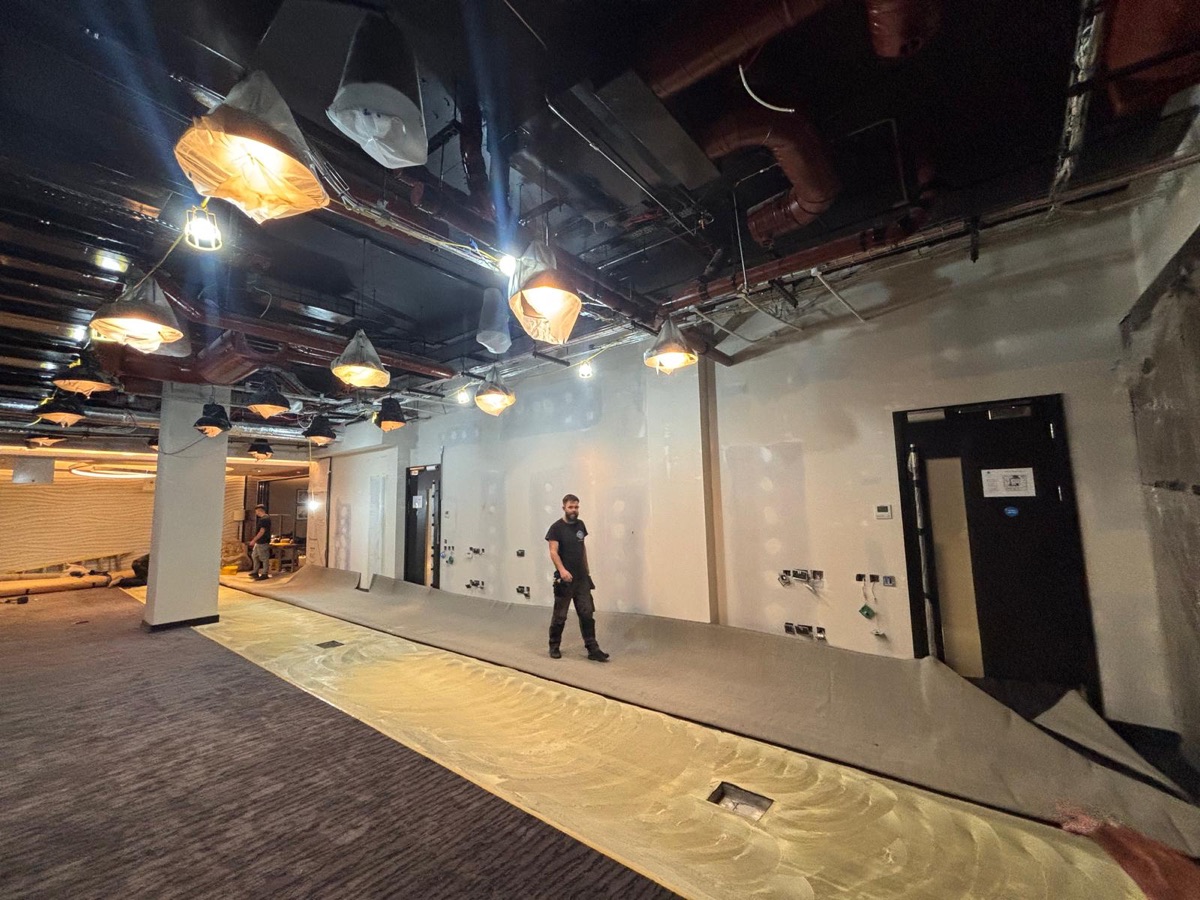 Open-plan commercial fit-out with new flooring and pendant lighting