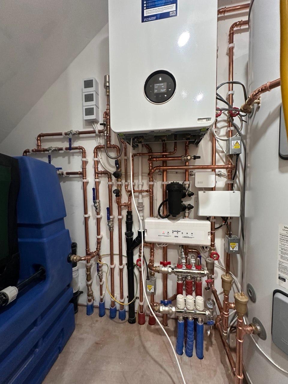 Combi boiler installation with copper pipework and manifold